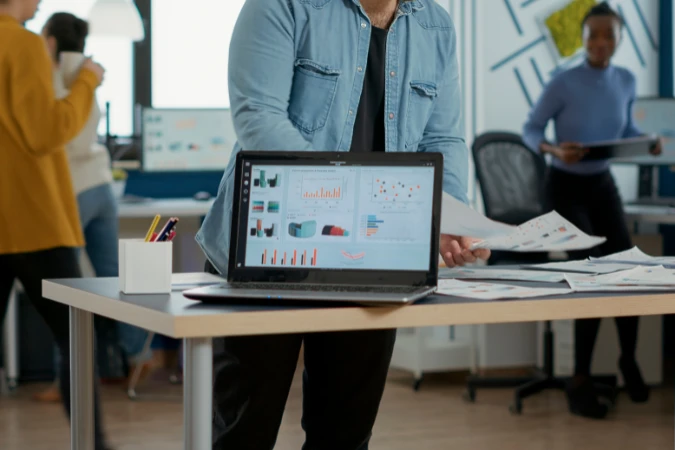 Profissional apresentando dashboard com gráficos e indicadores financeiros relacionados ao fluxo de caixa.