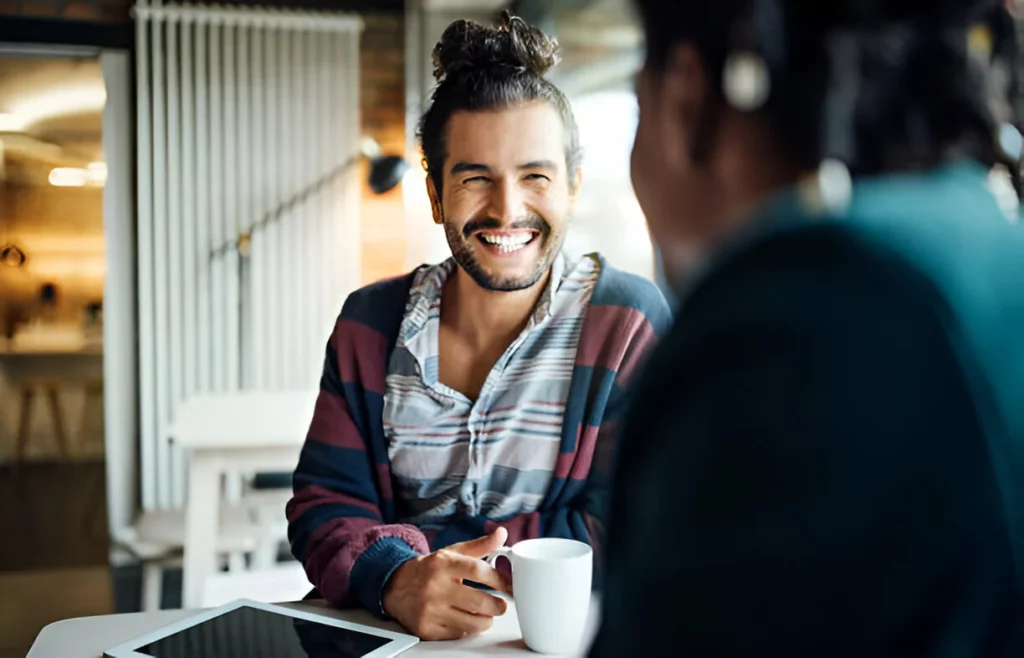 Happy businessman having coffee with colleague