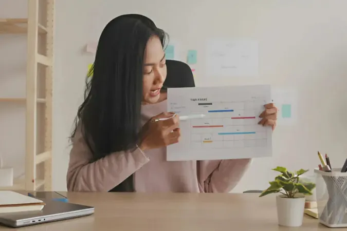 Profissionais revendo tarefas e prazos de projeto em ambiente de trabalho moderno