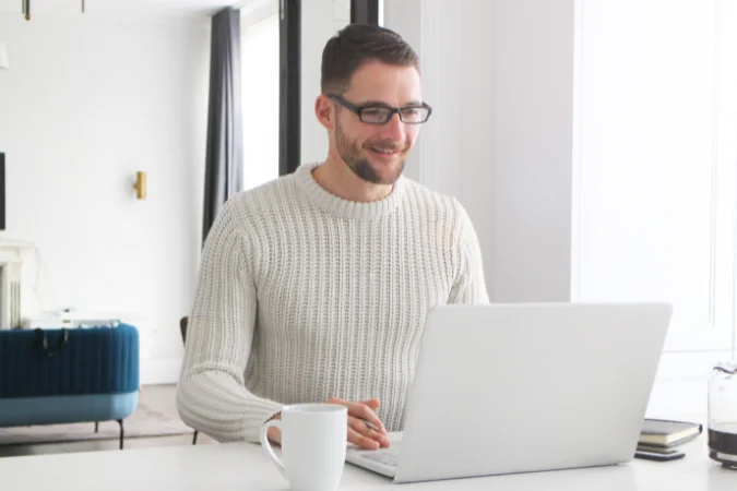 Profissional utilizando software de gestão de tarefas no computador para definir prioridades